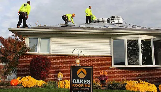 Workers replacing a roof on a home